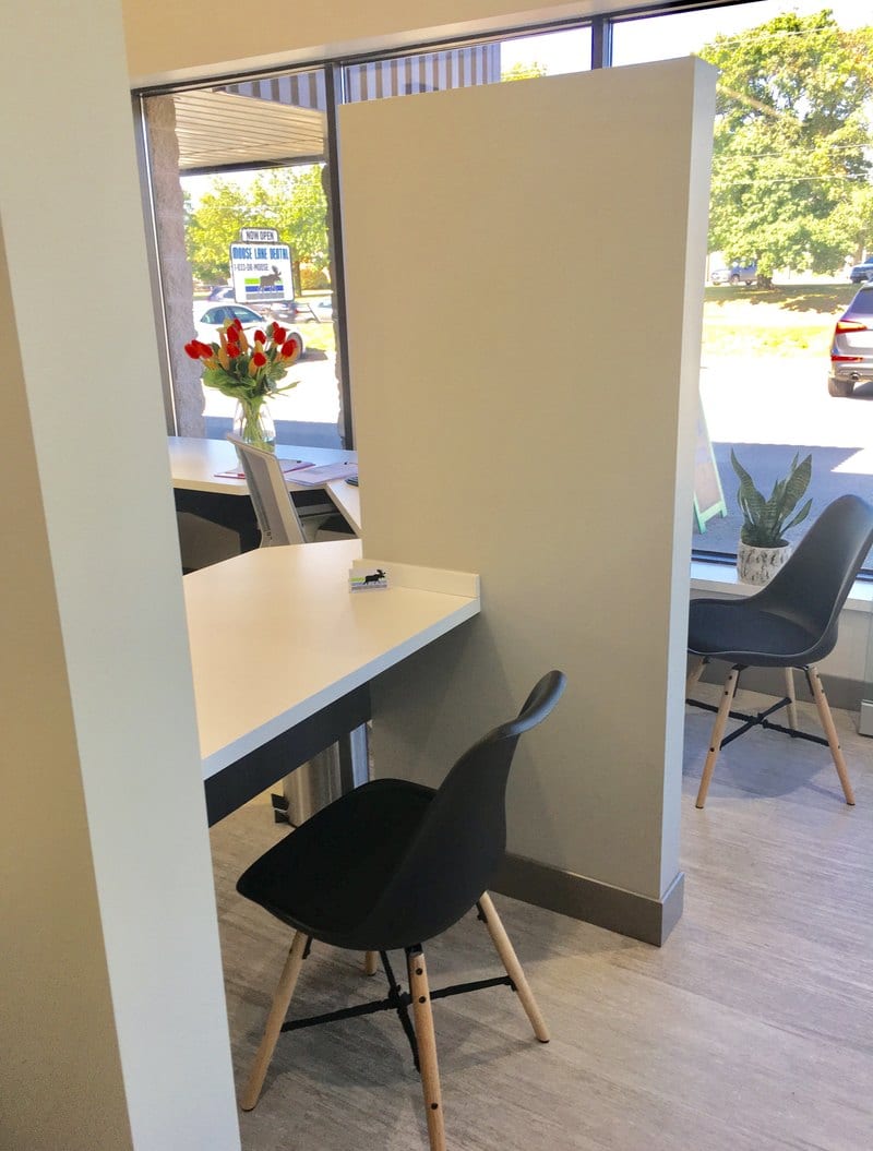 One of the two private consultation rooms at Moose Lake Dental, with flowers on the desk beside the window